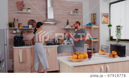 Married couple preparing breakfast Married couple preparing breakfast 67919778