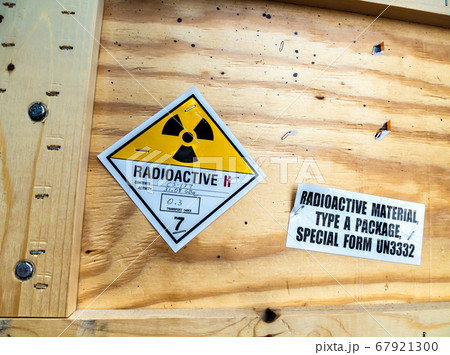 Radioactive material warning label beside the wooden package 67921300