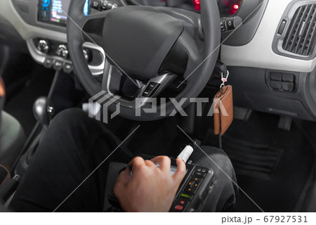 Man with diagnostic tools doing car diagnostic 67927531