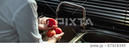 Asian hands woman washing vegetables tomato and 67928395