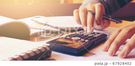 Woman using calculator with doing finance at home 67928402