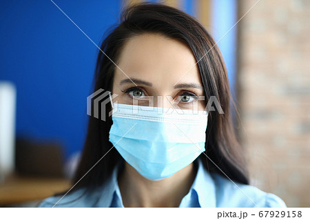 Woman in protective medical mask from viruses. Woman in protective medical mask from viruses. 67929158