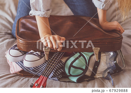 Female Packing Suitcase And Getting Ready For Travel Female Packing Suitcase And Getting Ready For Travel 67929888