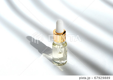 Anti aging serum with collagen and peptides in glass bottle with dropper. Anti aging serum with collagen and peptides in glass bottle with dropper. 67929889