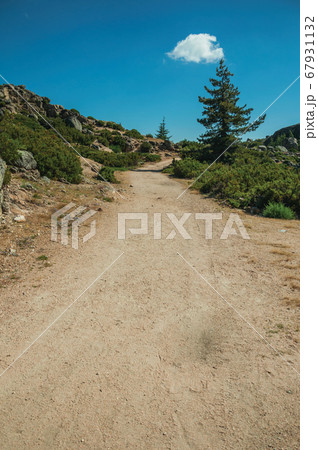 Trail passing through rocky formations on highlands Trail passing through rocky formations on highlands 67931132