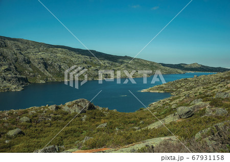 Hilly landscape with lake on highlands Hilly landscape with lake on highlands 67931158
