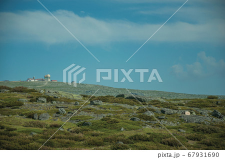 Rocky landscape with bushes and domes of an old radar station on the highlands 67931690