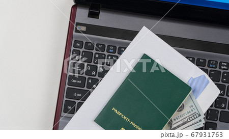 green passport on the keyboard 67931763