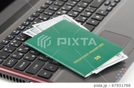 green passport on the keyboard 67931766