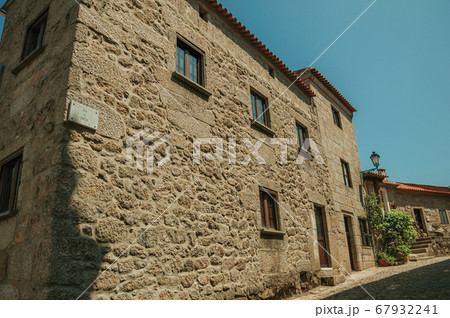 Old stone house and flowered bushes at Monsanto Old stone house and flowered bushes at Monsanto 67932241