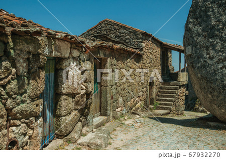 Old houses with stone wall and big round rock in Monsanto Old houses with stone wall and big round rock in Monsanto 67932270
