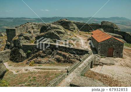 Stone walls encircling an old chapel at the Castle of Monsanto Stone walls encircling an old chapel at the Castle of Monsanto 67932853
