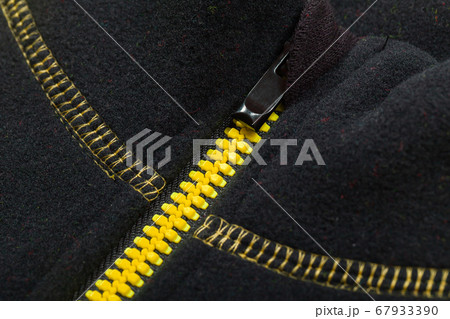 Yellow black zipper of a sports jacket, close-up Yellow black zipper of a sports jacket, close-up 67933390