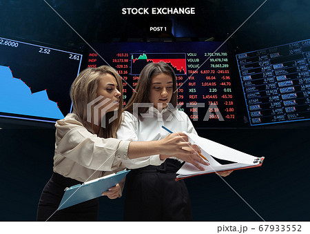 Nervous tensioned investors analyzing crisis stock market with charts on screen on background, falling stock exchange 67933552