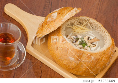 Soup in a bread bowl on the board Soup in a bread bowl on the board 67933669
