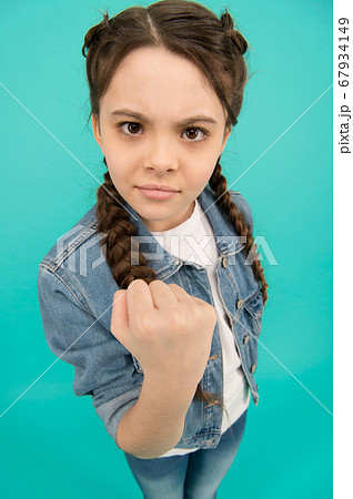 Threatening with fist. Angry child shake fist grey 67934149