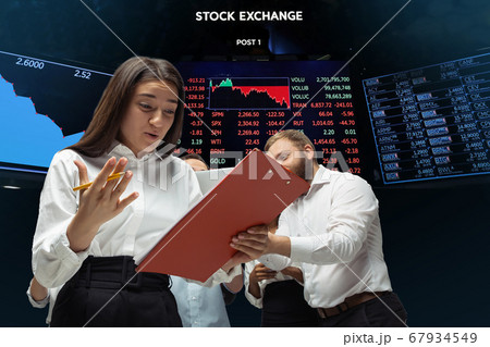 Nervous tensioned investors analyzing crisis stock market with charts on screen on background, falling stock exchange Nervous tensioned investors analyzing crisis stock market with charts on screen on background, falling stock exchange 67934549