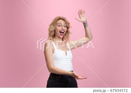 Caucasian young woman's portrait isolated on pink studio background. Beautiful female model. Concept of human emotions, facial expression, sales, ad, youth culture. 67934572
