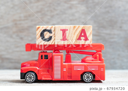 Red fire truck hold letter block in word CIA (abbreviation of certified internal auditor) on wood background 67934720