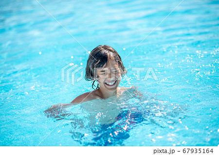 Boy in water smiling with closed eyes 67935164