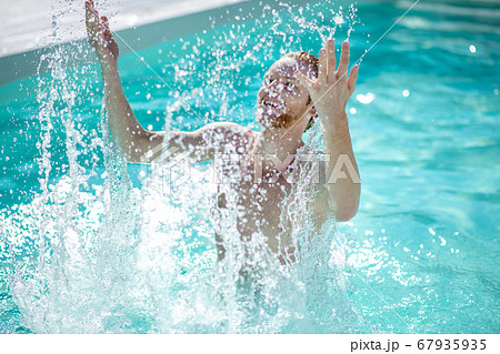 Man in the pool rejoicing in splashing water Man in the pool rejoicing in splashing water 67935935