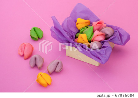 many colored cookies on a pink background 67936084