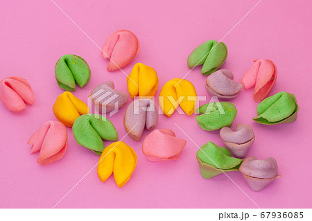 many colored cookies on a pink background 67936085
