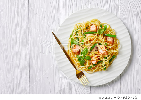 Salmon and green bean pasta on a plate, copy space 67936735