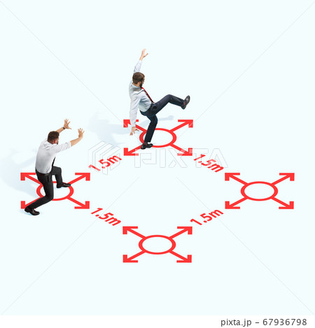 Studio shot of people demonstrating social distancing with arrows indicating the separation. Studio shot of people demonstrating social distancing with arrows indicating the separation. 67936798