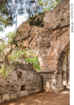 Ruins of aqueduct of ancient Phaselis city. Famous architectural landmark, Kemer district, Antalya province. Turkey. Ruins of aqueduct of ancient Phaselis city. Famous architectural landmark, Kemer district, Antalya province. Turkey. 67937376