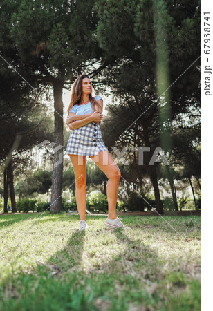 woman in sexy stylish dress posing in the city with standing on the road 67938741