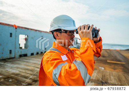 Filipino deck Officer on deck of vessel or ship , wearing PPE personal protective equipment 67938872