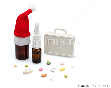 Cold medicine in Santa's hat and pills. 67939664