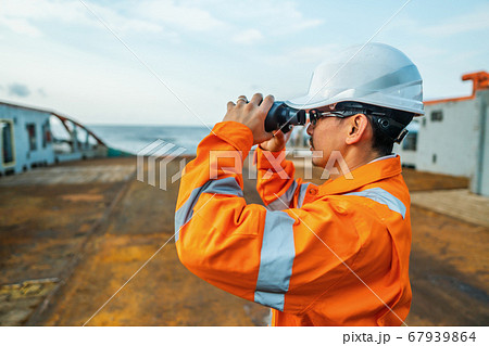 Filipino deck Officer on deck of vessel or ship , wearing PPE personal protective equipment Filipino deck Officer on deck of vessel or ship , wearing PPE personal protective equipment 67939864
