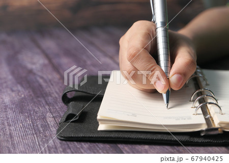 women hand writing with pen on notepad  67940425