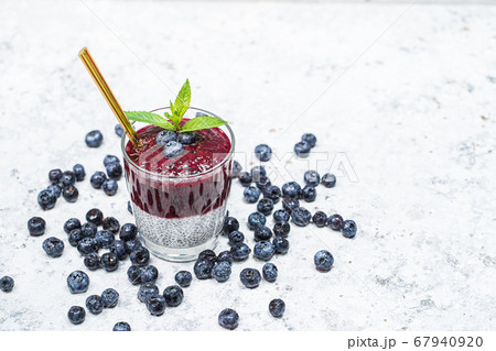 Healthy breakfast or morning snack with chia seeds and blueberries on white stone background, vegetarian food, diet and health concept Healthy breakfast or morning snack with chia seeds and blueberries on white stone background, vegetarian food, diet and health concept 67940920