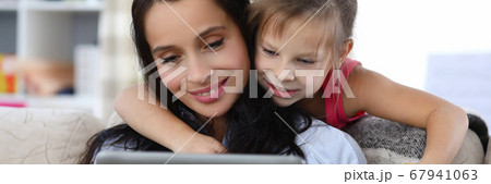 Relaxed smiling woman and happy child Relaxed smiling woman and happy child 67941063