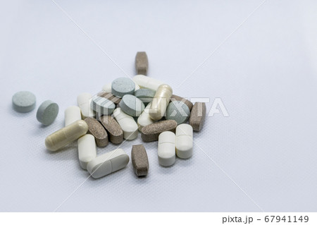Colored health drug pills on white background 67941149