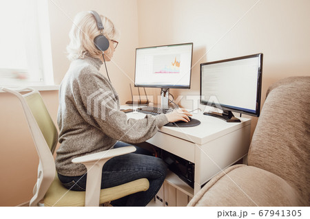 woman working at home with little child. woman working at home with little child. 67941305