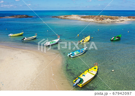 Small Fishing Boats anchored in a shallow lagoon, Aerial image. Small Fishing Boats anchored in a shallow lagoon, Aerial image. 67942097