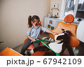 Little dentist treating toy patient 67942109