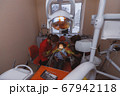 Female dentists healing teeth of little patient 67942118