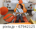 Cheerful little patient with huge toothbrush 67942125