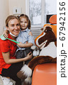 Cheerful dentist and patient hugging near horse toy 67942156