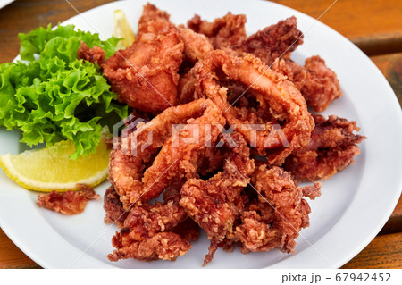 A plate full of fried squid in batter A plate full of fried squid in batter 67942452