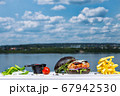 A close up of burger in front of a body of water 67942530