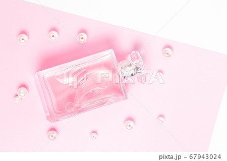pink perfume bottle with pearls on a pink sheet on a white background copy space. top view, mockup pink perfume bottle with pearls on a pink sheet on a white background copy space. top view, mockup 67943024