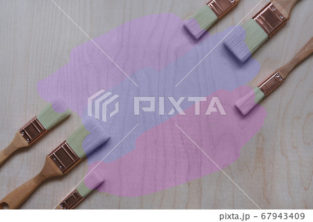 paint brushes on a plywood background 67943409