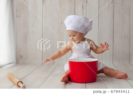 Little baby chef in apron. Little baby chef in apron. 67943411