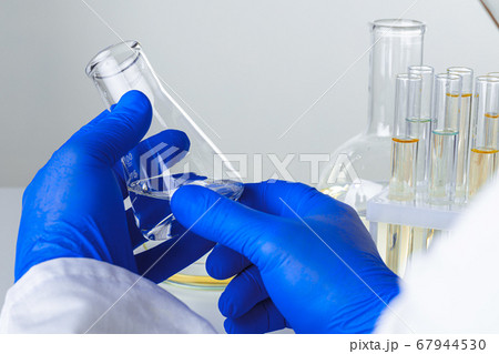 Close up of hands of a scientist working with laboratory samples Close up of hands of a scientist working with laboratory samples 67944530